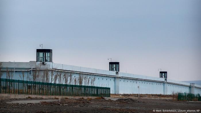 People stand in a guard tower on the perimeter wall of the Urumqi No. 3 Detention Center in Dabancheng in western China's Xinjiang Uyghur Autonomous Region