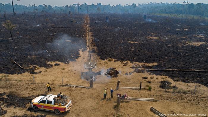 Des travailleurs de l'agence environnementale brésilienne IBAMA discutent avec un agriculteur d'une zone détruite par un incendie près de Novo Progresso, dans l'État de Para, au Brésil