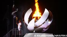Tokyo 2020 Olympics - The Tokyo 2020 Olympics Opening Ceremony - Olympic Stadium, Tokyo, Japan - July 23, 2021. Naomi Osaka of Japan holds the Olympic torch after lighting the Olympic cauldron at the opening ceremony REUTERS/Kai Pfaffenbach