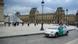 An electric car is shown, parked outside of the Louvre An electric car is shown, parked outside of the Louvre