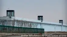 A person stands in a tower on the perimeter of the Number 3 Detention Center in Dabancheng in western China's Xinjiang Uyghur Autonomous Region on April 23, 2021. Human rights groups and Western nations led by the United States, Britain and Germany accused China of massive crimes against the Uyghur minority and demanded unimpeded access for U.N. experts at a virtual meeting on Wednesday, May 12, 2021 denounced by China as politically motivated and based on lies. (AP Photo/Mark Schiefelbein)