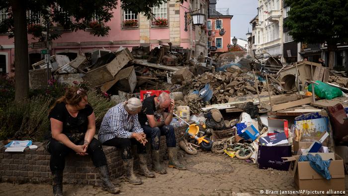 People rest from cleaning up debris in Bad Neuenahr-Ahrweiler