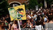 People taking part in a gay pride parade hold a banner depicting Hungarian Prime Minister Viktor Orban in Budapest, Hungary, Saturday, July 24, 2021. Hungary's government led by right-wing Prime Minister Viktor Orban passed a law in June prohibiting the display of content depicting homosexuality or gender reassignment to minors, a move that has ignited intense opposition in Hungary while EU lawmakers have urged the European Commission to take swift action against Hungary unless it changes tack. (AP Photo/Anna Szilagyi)