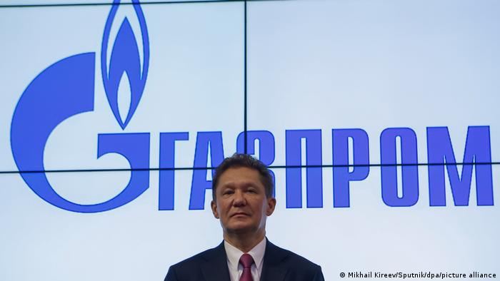 Gazprom CEO Alexei Miller pictured in front of a Gazprom logo