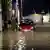 People wade through flooded streets of Belgium's Namur following heavy rains on July 24
