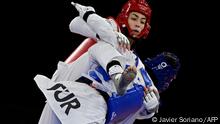 Turkey's Hatice Kubra Ilgun (Blue) and Refugee Olympic Team's Kimia Alizadeh Zenoorin (Red)
compete in the taekwondo women's -57kg bronze medal B bout during the Tokyo 2020 Olympic Games at the Makuhari Messe Hall in Tokyo on July 25, 2021. (Photo by Javier SORIANO / AFP)