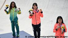 (LtoR) Brazil's Rayssa Leal (silver), Japan's Momiji Nishiya (gold) and Japan's Funa Nakayama (bronze) pose during the medal ceremony of the podium ceremony of the skateboarding women's street final of the Tokyo 2020 Olympic Games at Ariake Sports Park in Tokyo on July 26, 2021. (Photo by Lionel BONAVENTURE / AFP) (Photo by LIONEL BONAVENTURE/AFP via Getty Images)