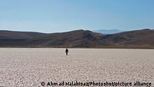 (191112) -- FARS, Nov. 12, 2019 () -- A man walks on the dried-up part of the Maharloo Lake in Fars Province, southern Iran, Nov. 11, 2019. A large part of Maharloo Lake has almost disappeared over the past years due to drought. (Photo by Ahmad Halabisaz/)