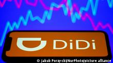 DiDi logo displayed on a phone screen is seen with illustrative stock chart in the background in this illustration photo taken in Krakow, Poland on July 8, 2021. (Photo by Jakub Porzycki/NurPhoto)