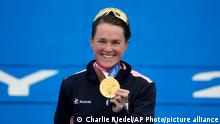 Flora Duffy of Bermuda holds her gold medal during a medal ceremony for the women's individual triathlon competition at the 2020 Summer Olympics, Tuesday, July 27, 2021, in Tokyo, Japan. (AP Photo/Charlie Riedel)