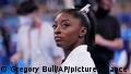 Simone Biles, of the United States, waits for her turn to perform during the artistic gymnastics women's final at the 2020 Summer Olympics, Tuesday, July 27, 2021, in Tokyo. (AP Photo/Gregory Bull)