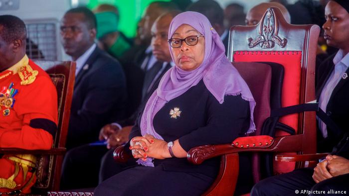 Tanszania's President Samia Suluhu Hassan sits in a chair with her hands clasped