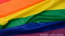 textile rainbow flag with waves, symbol of freedom of choice of lesbians, gays, bisexuals and transgender people, LGBT culture, close up