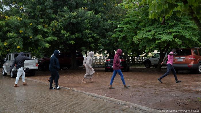 People walk across the street after leaving 