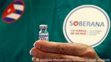 (210401) -- HAVANA, April 1, 2021 (Xinhua) -- A medical worker presents a dose of locally made COVID-19 vaccine Soberana 02 in Havana, Cuba on March 31, 2021. The Soberana 02 vaccine has entered phase 3 clinical trials earlier in March in Havana. (Photo by Joaquin Hernandez/Xinhua)