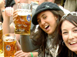 Young women toast the camera at Oktoberfest