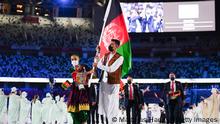 TOKYO, JAPAN - JULY 23: Flag bearers Kimia Yousofi and Farzad Mansouri of Team Afghanistan lead their team during the Opening Ceremony of the Tokyo 2020 Olympic Games at Olympic Stadium on July 23, 2021 in Tokyo, Japan. (Photo by Matthias Hangst/Getty Images)