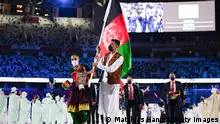 TOKYO, JAPAN - JULY 23: Flag bearers Kimia Yousofi and Farzad Mansouri of Team Afghanistan lead their team during the Opening Ceremony of the Tokyo 2020 Olympic Games at Olympic Stadium on July 23, 2021 in Tokyo, Japan. (Photo by Matthias Hangst/Getty Images)