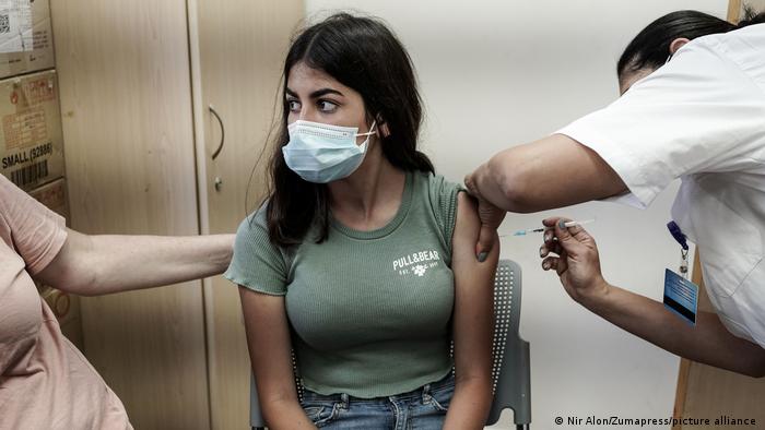 A young woman in Jerusalem gets a COVID-19 vaccination