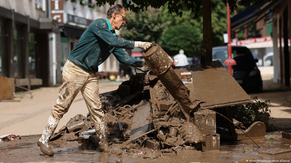 Person cleaning up debris after flooding