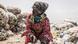 A woman ties her sack of recyclable waste in Dakar on July 14, 2021 A woman ties her sack of recyclable waste in Dakar on July 14, 2021