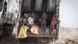 Three men and a child on the back of a garbage truck at the Mbeubeuss rubbish dump in Dakar, Senegal Three men and a child on the back of a garbage truck at the Mbeubeuss rubbish dump in Dakar, Senegal