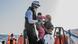 A rescuer with the Ocean Viking lifts up a child from a boat during a migrant rescue operation A rescuer with the Ocean Viking lifts up a child from a boat during a migrant rescue operation