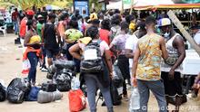 Stranded migrants from Cuba, Haiti and several African countries are seen in Necocli, Colombia, on July 28, 2021. - Thousands of migrants are stranded in a Colombian port town as they wait for boats to cross into neighboring Panama on their way to the United States, a state relief agency said. (Photo by David Cuello / AFP)