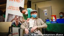 TEL AVIV, ISRAEL - DECEMBER 31: Nurse Edna Gabay injects Pfizer-BioNTech's coronavirus (COVID-19) vaccine to 100 years old Yaakov Haimovic at an elderly home in Ramat Aviv Neighborhood in Tel Aviv Israel on December 31, 2020. Nir Keidar / Anadolu Agency
