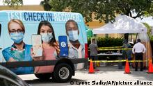 People wait in line at a Miami-Dade County COVID-19 testing site, Monday, July 26, 2021, in Hialeah, Fla. Florida accounted for a fifth of the nation's new infections last week, more than any other state, according to the U.S. Centers for Disease Control and Prevention. (AP Photo/Lynne Sladky)