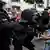 Police scuffle with a protester 