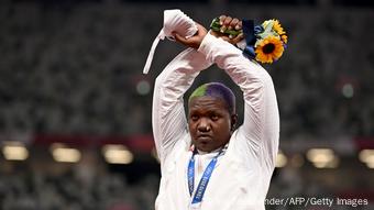 Raven Saunders, the American silver medalist, crosses her arms over her head in an X shape and honors the descendants.