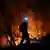 A firefighter battles a blaze near Patras, Greece.
