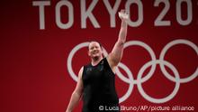 Laurel Hubbard of New Zealand waves after a lift, in the women's 87kg weightlifting event at the 2020 Summer Olympics, Monday, Aug. 2, 2021, in Tokyo, Japan. (AP Photo/Luca Bruno)