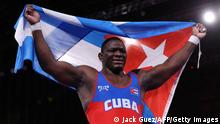 Cuba's Mijain Lopez Nunez celebrates his gold medal win against Georgia's Iakobi Kajaia in their men's greco-roman 130kg wrestling final match during the Tokyo 2020 Olympic Games at the Makuhari Messe in Tokyo on August 2, 2021. (Photo by Jack GUEZ / AFP) (Photo by JACK GUEZ/AFP via Getty Images)