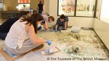 The Museum team, conservator
and student volunteers retrieve fragments of broken glass
vessels from amongst the shattered glass from the display case and nearby windows, at the
Archaeological Museum, AUB
.
Courtesy of the AUB Office of Communications and Archaeological Museum