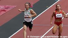 30.7.2021**** This file photo taken on July 30, 2021 shows Belarus' Krystsina Tsimanouskaya (L) and Spain's Maria Isabel Perez competing in the women's 100m heats during the Tokyo 2020 Olympic Games at the Olympic Stadium in Tokyo. - Poland has granted a humanitarian visa to Krystsina Tsimanouskaya, a Belarusian Olympic athlete who claimed her team tried to force her to leave Japan, Poland's deputy foreign minister said on August 2, 2021. (Photo by Giuseppe CACACE / AFP) (Photo by GIUSEPPE CACACE/AFP via Getty Images)