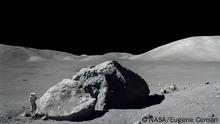 On Dec. 13, 1972, scientist-astronaut Harrison H. Schmitt is photographed standing next to a huge, split lunar boulder during the third Apollo 17 extravehicular activity (EVA) at the Taurus-Littrow landing site. The Lunar Roving Vehicle (LRV), which transported Schmitt and Eugene A. Cernan to this extravehicular station from their Lunar Module (LM), is seen in the background. The mosaic is made from two frames from Apollo 17 Hasselblad magazine 140. The two frames were photographed by Cernan.
Image Credit: NASA/Eugene Cernan