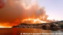 Flames burn on the mountain near Limni village on the island of Evia, about 160 kilometers (100 miles) north of Athens, Greece, Tuesday, Aug. 3, 2021. Greece Tuesday grappled with the worst heatwave in decades that strained the national power supply and fueled wildfires near Athens and elsewhere in southern Greece. As the heat wave scorching the eastern Mediterranean intensified, temperatures reached 42 degrees Celsius (107.6 Fahrenheit) in parts of the Greek capital. (AP Photo/Michael Pappas)