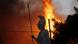 A statue of the goddess Athena is seen against raging flames A statue of the goddess Athena is seen against raging flames