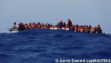 Some 89 migrants on a wooden boat wait to be rescued during a joint rescue operation between the German NGO migrant rescue ship Sea-Watch 3 and the Italian Coast Guard some 63 nautical miles south-west of the Italian island of Lampedusa, in the western Mediterranean Sea, August 2, 2021. REUTERS/Darrin Zammit Lupi TPX IMAGES OF THE DAY