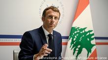 France's President Emmanuel Macron gestures as he attends an international video conference at the Fort de Bregancon, in Bormes-Les-Mimosas, southern France, Wednesday, Aug. 4, 2021. The virtual event, co-hosted by France and the United Nations, is meant to show support towards Lebanese people, French President Emmanuel Macron said. France will provide 100 millions euros ($118.6 million) in the coming months, Macron said in his opening remarks. (Christophe Simon/Pool Photo via AP)