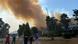Workers at a power plant in Milas, Turkey, with smoke from wildfire Workers at a power plant in Milas, Turkey, with smoke from wildfire