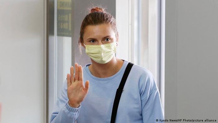 Krystsina Tsimanouskaya waves as she leaves Narita International Airport in Narita, east of Tokyo