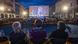 Audience members watch Festival President Luciano Giudici onscreen at the Piazza Grande Audience members watch Festival President Luciano Giudici onscreen at the Piazza Grande