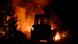 A tractor is silhouetted against a raging fire A tractor is silhouetted against a raging fire