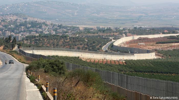 A large wall marks the border area between Israel and Lebanon