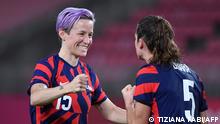 USA's forward Megan Rapinoe (L) celebrates with teammate defender Kelley O'Hara after winning the Tokyo 2020 Olympic Games women's bronze medal football match between Australia and the United States at Ibaraki Kashima Stadium in Kashima city, Ibaraki prefecture on August 5, 2021. (Photo by Tiziana FABI / AFP)