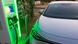 An electric car recharging at a public charging station An electric car recharging at a public charging station