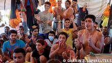 Migrants on the German NGO migrant rescue ship Sea-Watch 3 react to the news that the ship has been assigned a port of safety and will arrive in Trapani, Sicily, to disembark them the following morning off the coast of the island of Sicily, Italy, August 6, 2021. REUTERS/Darrin Zammit Lupi